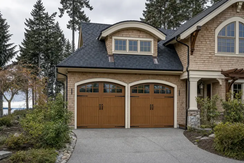 A faux-wood carriage house door on a tree-lined Vancouver street